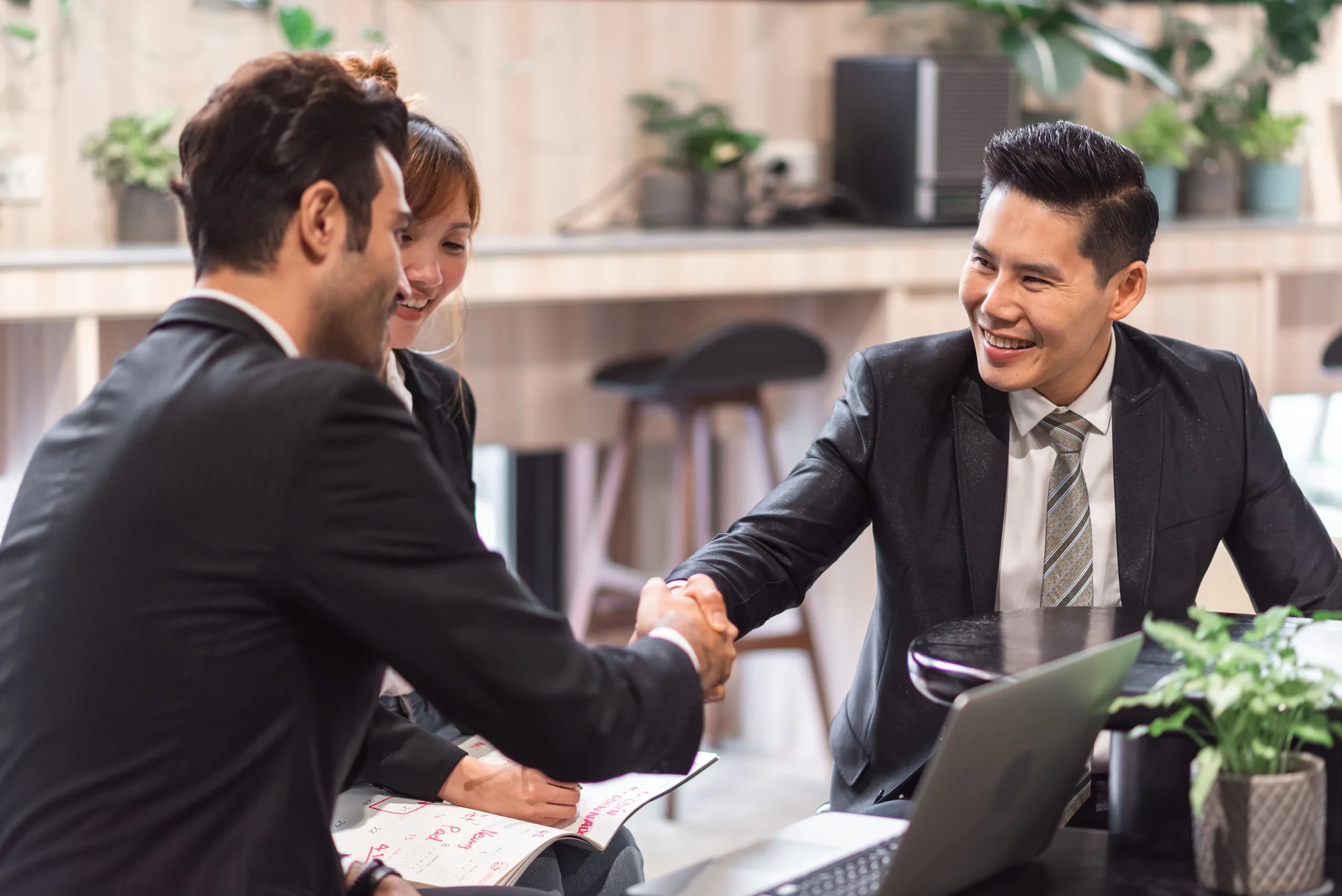 Two business partners shaking hands over a deal